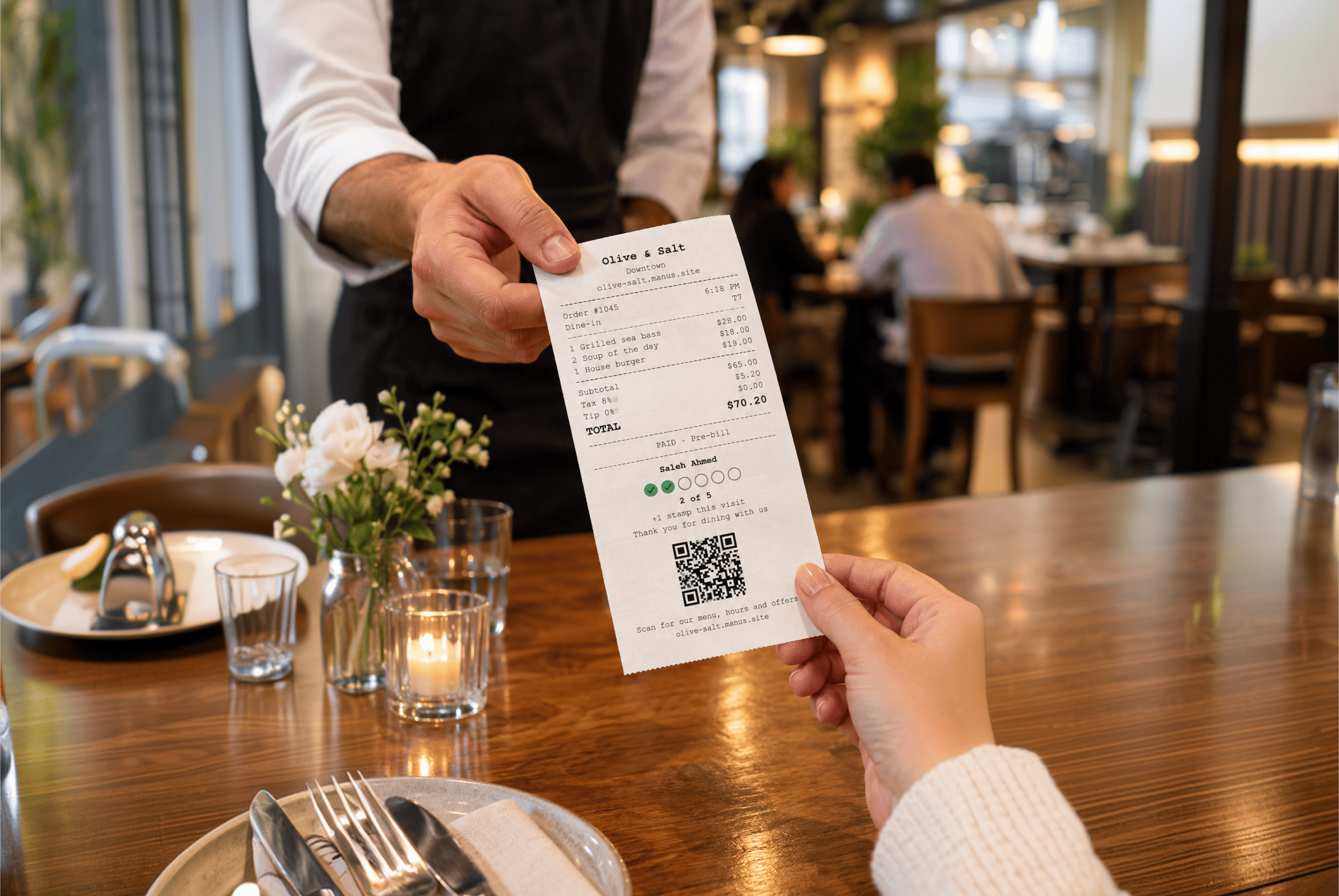 Waiter handing a guest an Olive & Salt receipt with stamp card progress and website QR code